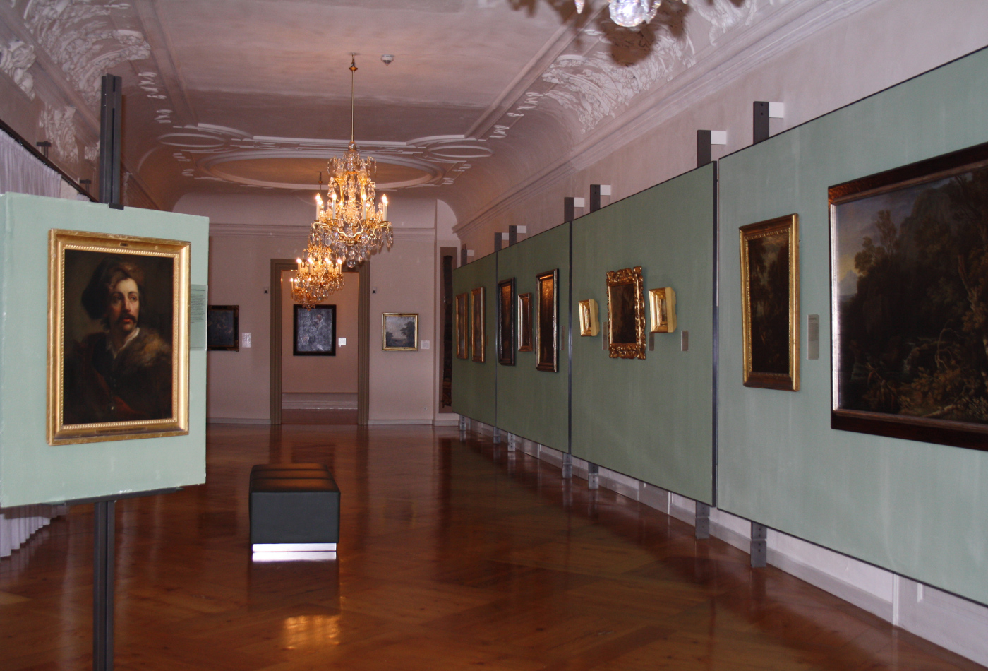 Blick in einen langen Flur der Barockgalerie, in der zahlreiche Gemälde hängen.