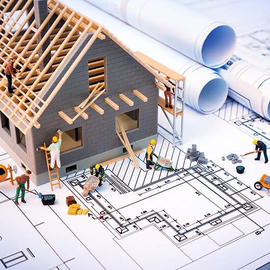 Miniatur-Modelhaus auf einem Bauplan