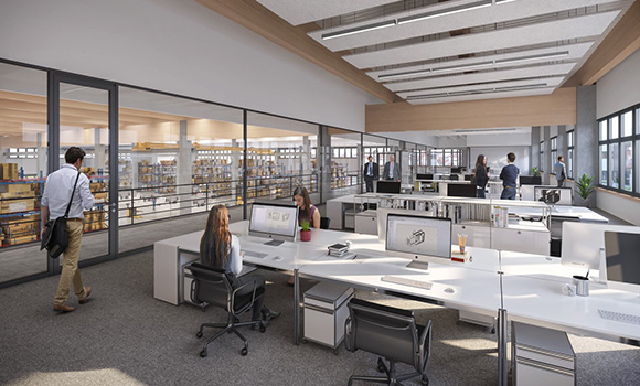 Meschen sitzen und stehen in einem Großraumbüro.