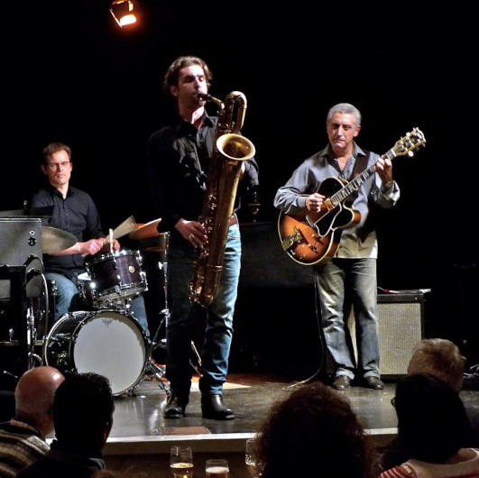 Jazzmusiker stehen auf einer Bühne.